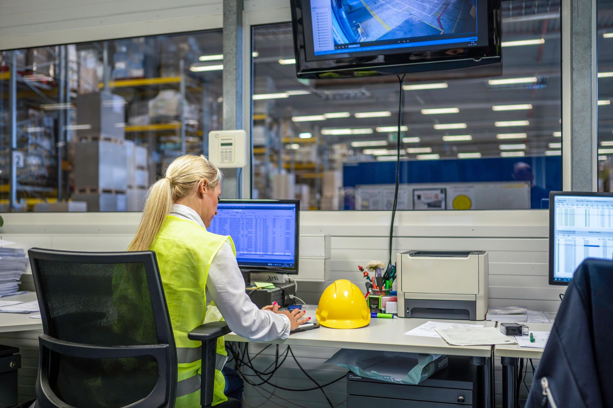 Industrial operations manager coordinating work from site office