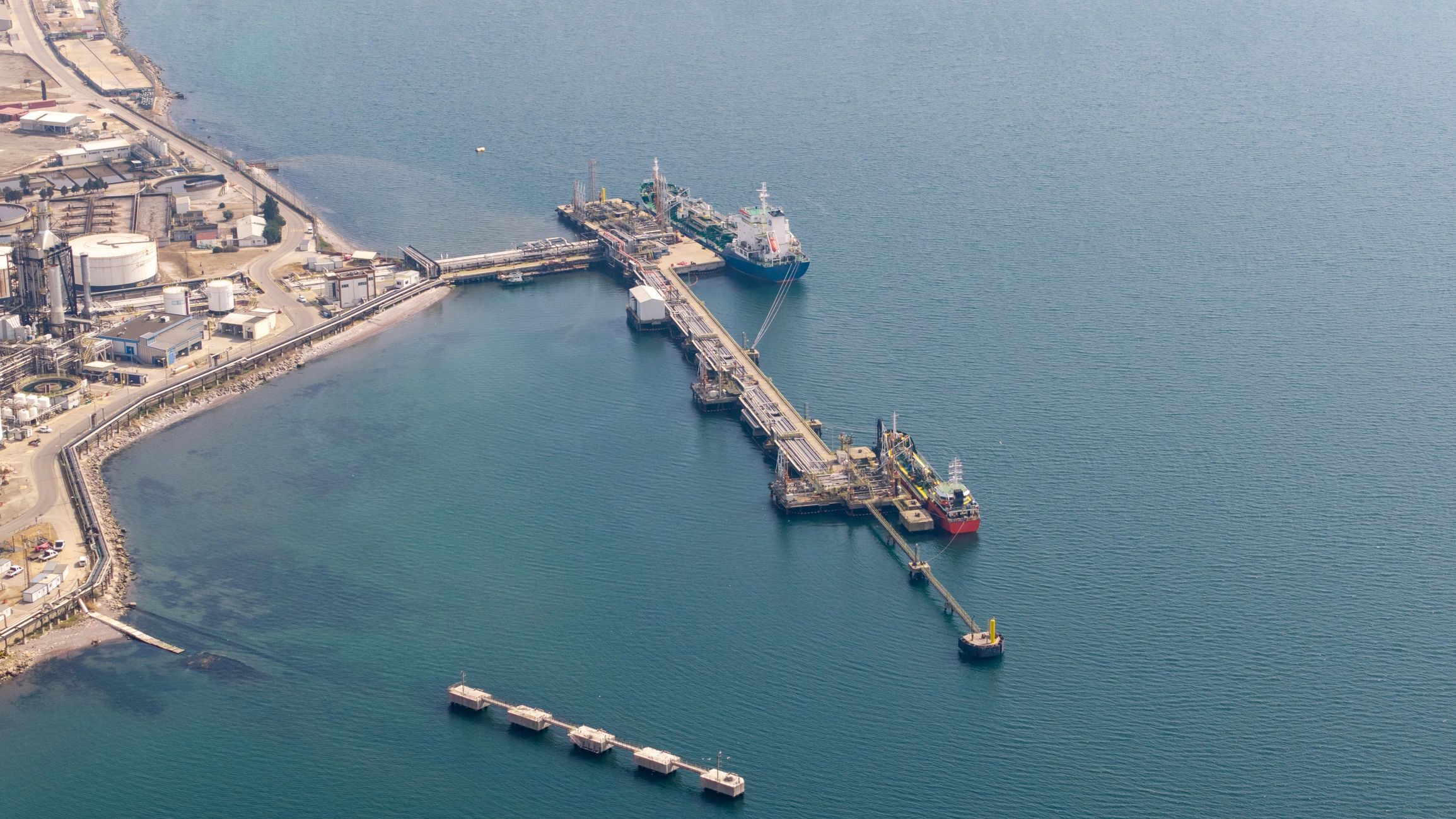 Cargo ships docking at industrial oil refinery port